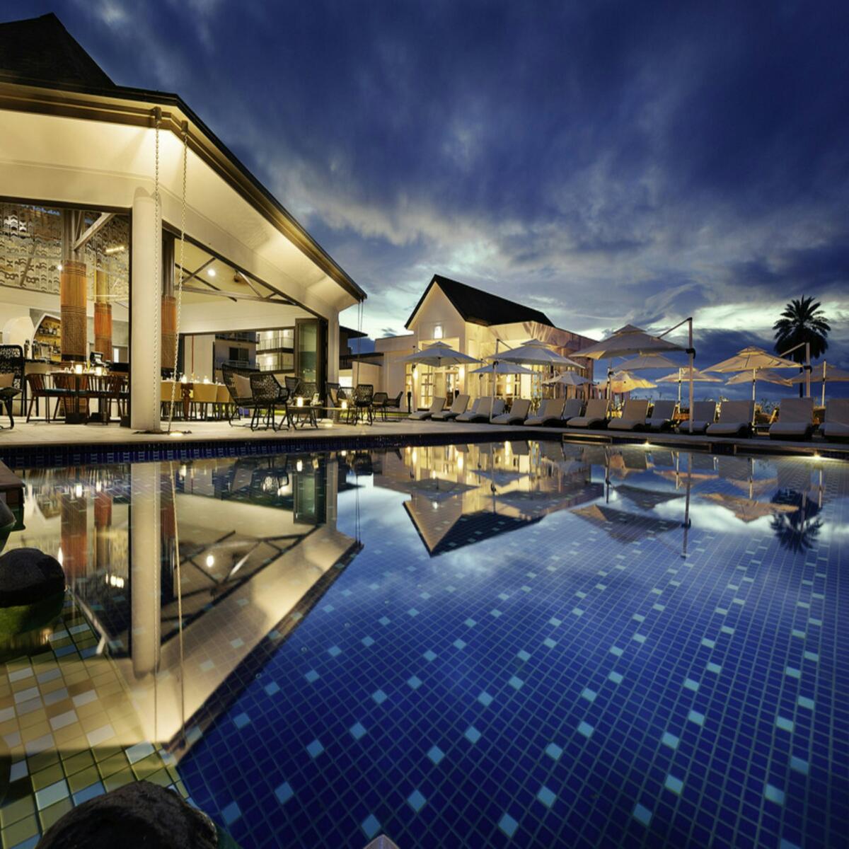 Palm-lined resort and swimming pool, illustrative placeholder